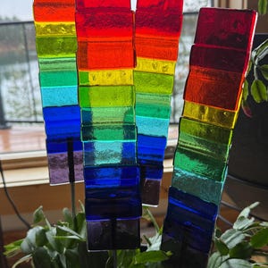 May include: A rustic wooden sign with the text "Welcome to our home" in white lettering. The sign features a distressed finish and a simple, inviting design, perfect for a front porch or entryway.