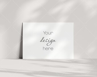 Puede incluir: Una tarjeta blanca con el texto "Your design here" sobre un fondo blanco con sombras.