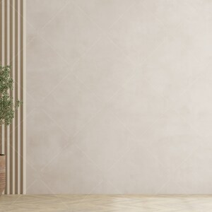 May include: A small potted plant with green leaves in a brown ceramic pot sits in front of a wall with vertical wood panels. The wall is a light beige colour.