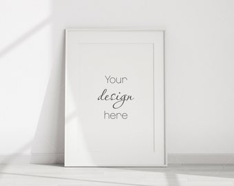 May include: A white picture frame with a white mat and a white background. The text "Your design here" is written in black cursive on the white mat.