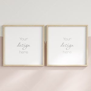 May include: Two wooden picture frames with white mats and the text "Your design here" in each frame. The frames are hanging on a light pink wall with a white border.