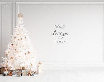May include: A white Christmas tree decorated with gold ornaments and white stars, with presents wrapped in gold and black paper underneath. The tree is in front of a white wall with the text "Your design here".