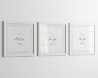 May include: Three white picture frames with a white mat and a white background. The frames are hanging on a white wall. The text "Your design here" is written in black cursive inside each frame.