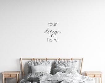 May include: A white bedroom with a wooden bed frame and gray bedding. The bed has two pillows and a throw blanket. There are two wooden nightstands on either side of the bed. The text "Your design here" is written on the wall above the bed.