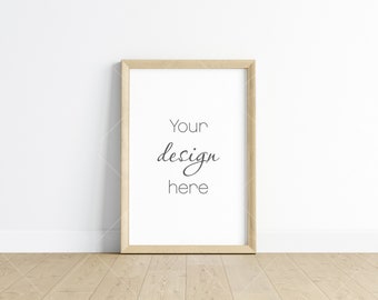 May include: A simple wooden frame with a white background and the text "Your design here" in black cursive writing.