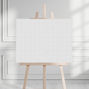 May include: A blank canvas on an easel in a white room with natural light.