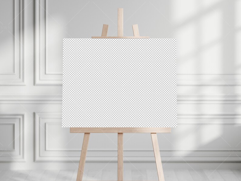 May include: A blank canvas on an easel in a white room with natural light.