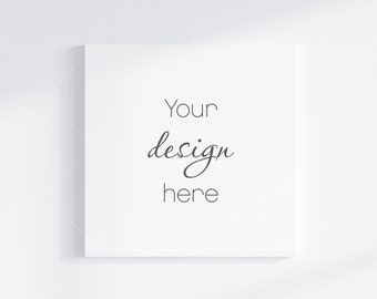 Puede incluir: Lienzo blanco cuadrado con el texto "Your design here" en negro.