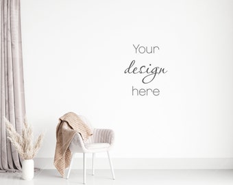 May include: A white chair with a beige throw blanket draped over the back, a vase with dried pampas grass, and a gray curtain in the background. The wall is white with the text "Your design here" written in black.