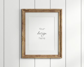 May include: A brown wooden frame with a white mat and a white background. The text "Your design here" is written in black cursive font.