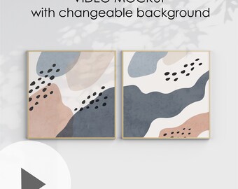 Peut inclure: Deux impressions d'art abstrait encadrées avec un fond blanc et des formes abstraites dans des tons de bleu, rose et noir. Les cadres sont en bois clair. Le texte "VIDEO MOCKUP with changeable background" est en haut de l'image. Le texte "1x1 ratio" est en bas de l'image.