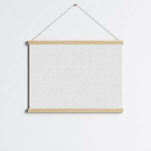 May include: A wooden frame with a blank canvas hanging on a white wall. The frame is attached to a string and has a simple, minimalist design.