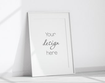 May include: A white picture frame with a white mat and a white background. The text "Your design here" is written in black cursive font.