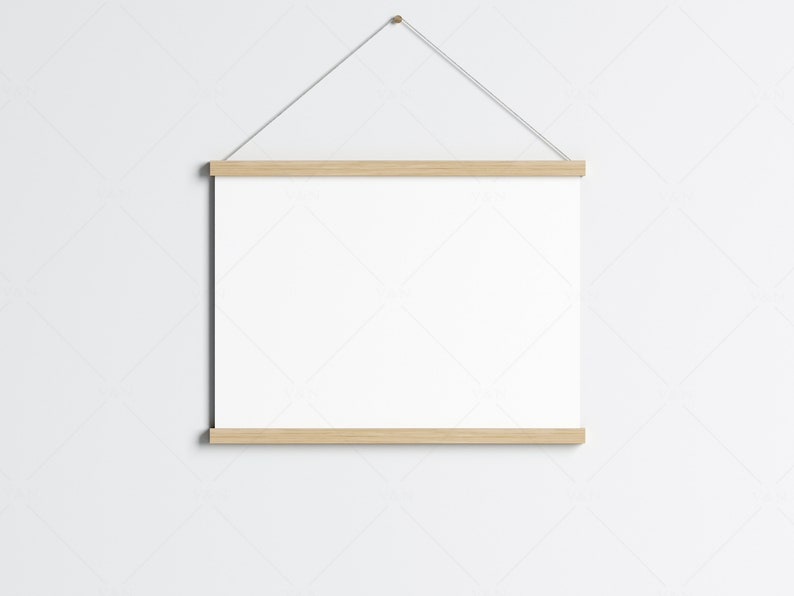 May include: A white poster with a wooden frame hanging on a white wall. The frame is attached to a string.