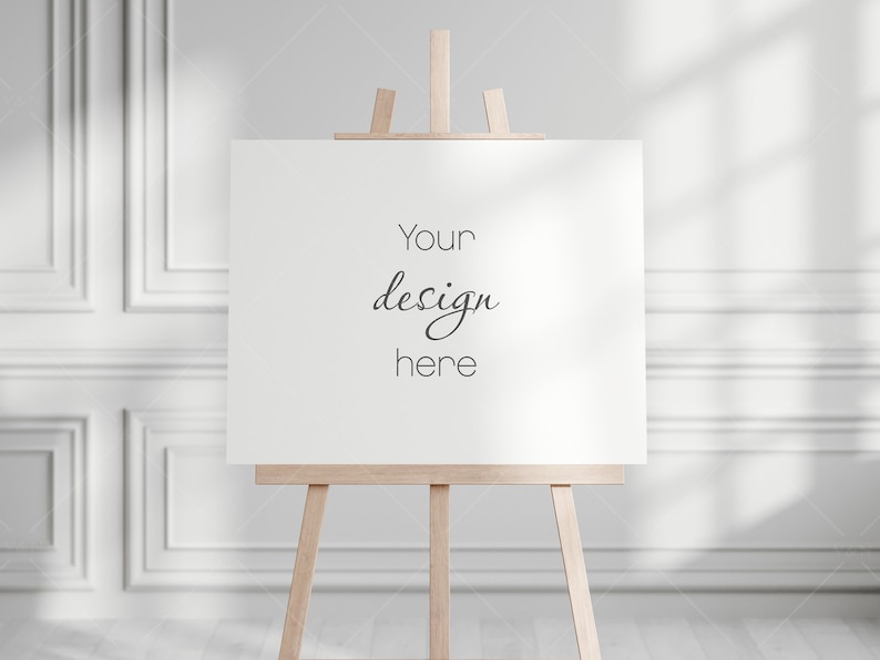 May include: A white canvas on a wooden easel with the text "Your design here" in black.