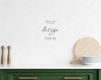 May include: A white tiled kitchen backsplash with a wooden cutting board and a stack of white plates. There are two wooden salt and pepper shakers on the counter. The text "Your design here" is written on the backsplash.