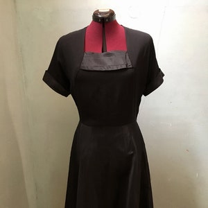 1950s black crepe and taffeta cocktail dress with short sleeves and square neckline W 32"