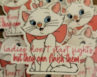 May include: White cat sticker with a pink bow and the text "Ladies don't start fights but they can finish them." The cat has blue eyes and a pink nose. The sticker is a cartoon design.