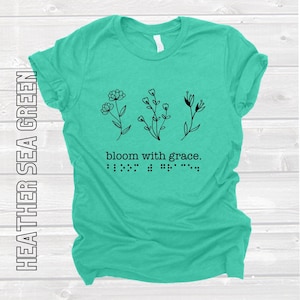 bloom with grace. softstyle t-shirt with braille and print