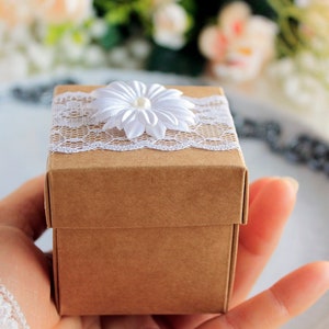 Every souvenir will come in a kraft origami gift box, adorned with white lace and beautiful white silk flower with pearl in a middle.