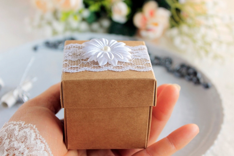 Every souvenir will come in a kraft origami gift box, adorned with white lace and beautiful white silk flower with pearl in a middle.