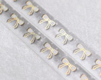 May include: Two clear plastic straws with gold glitter and a repeating pattern of gold bows.