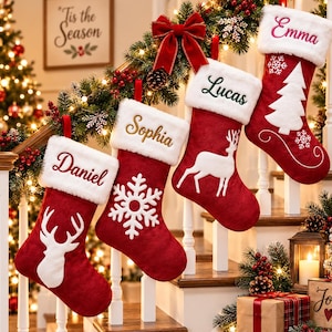 May include: Four red Christmas stockings with white faux fur cuffs, each personalised with embroidered names: Daniel, Sophia, Lucas, and Emma. The stockings feature white felt appliqués of a deer head, a snowflake, a standing deer, and a pine tree.