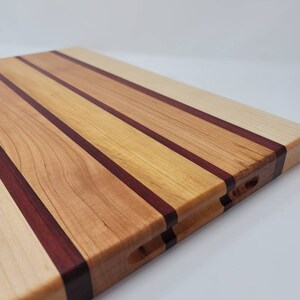 Handmade hard wood cutting or serving board with maple, cherry and padauk