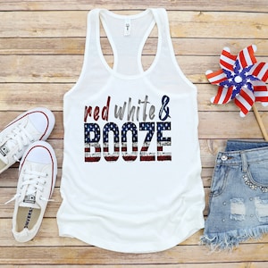 May include: White tank top with a red, white, and blue American flag design and the text "red white & booze".