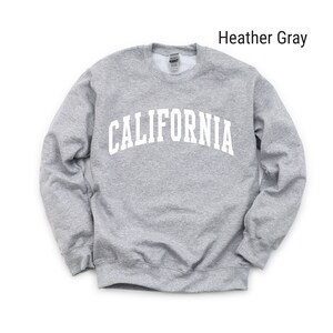May include: Heather grey sweatshirt with the word "CALIFORNIA" printed in white on the front.