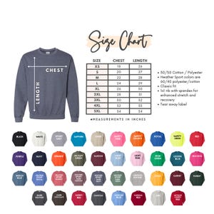 May include: Size chart for a sweatshirt with measurements in inches for chest and length. The chart shows sizes from XS to 5XL. The sweatshirt is available in a variety of colors, including black, white, sport grey, sapphire, sand, safety pink, safety orange, royal, safety green, red, purple, navy, orange, military green, maroon, light blue, light pink, Irish green, legion blue, heliconia, indigo blue, heather sport royal, heather sport scarlet, heather sport maroon, heather sport dark navy, heather sport dark green, graphite heather, gold, garnet, forest, dark heather, dark chocolate, cherry red, charcoal, carolina blue, cardinal red, ash, and antique cherry red.