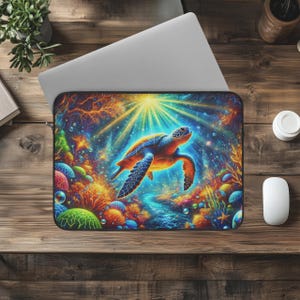 May include: A laptop sleeve featuring a vibrant, colorful illustration of a sea turtle swimming in a coral reef. The design includes shades of blue, orange, and yellow, with a bright light shining from above. The sleeve is designed to protect a laptop.