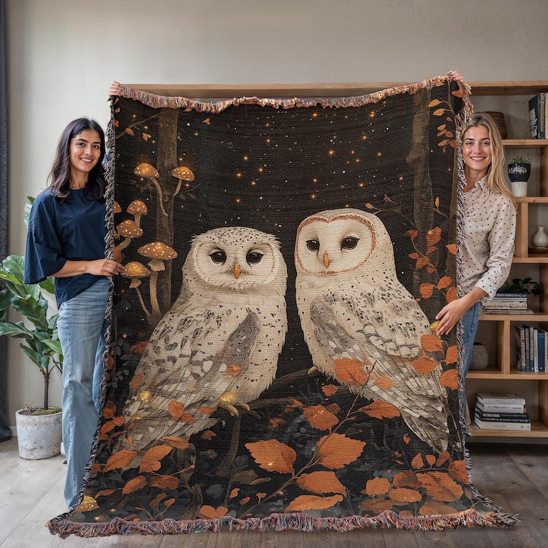 Magical woodland cottagecore throw blanket with two white owls among glowing mushrooms and autumn leaves on dark starry background, cotton woven tapestry with fringe