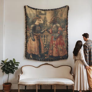 Woven blanket showing two goats in medieval armor and gowns on a castle terrace, surrounded by flowers and historical fantasy scenery