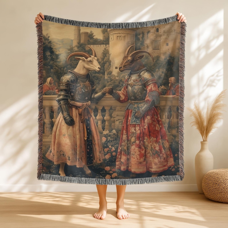 Woven blanket showing two goats in medieval armor and gowns on a castle terrace, surrounded by flowers and historical fantasy scenery