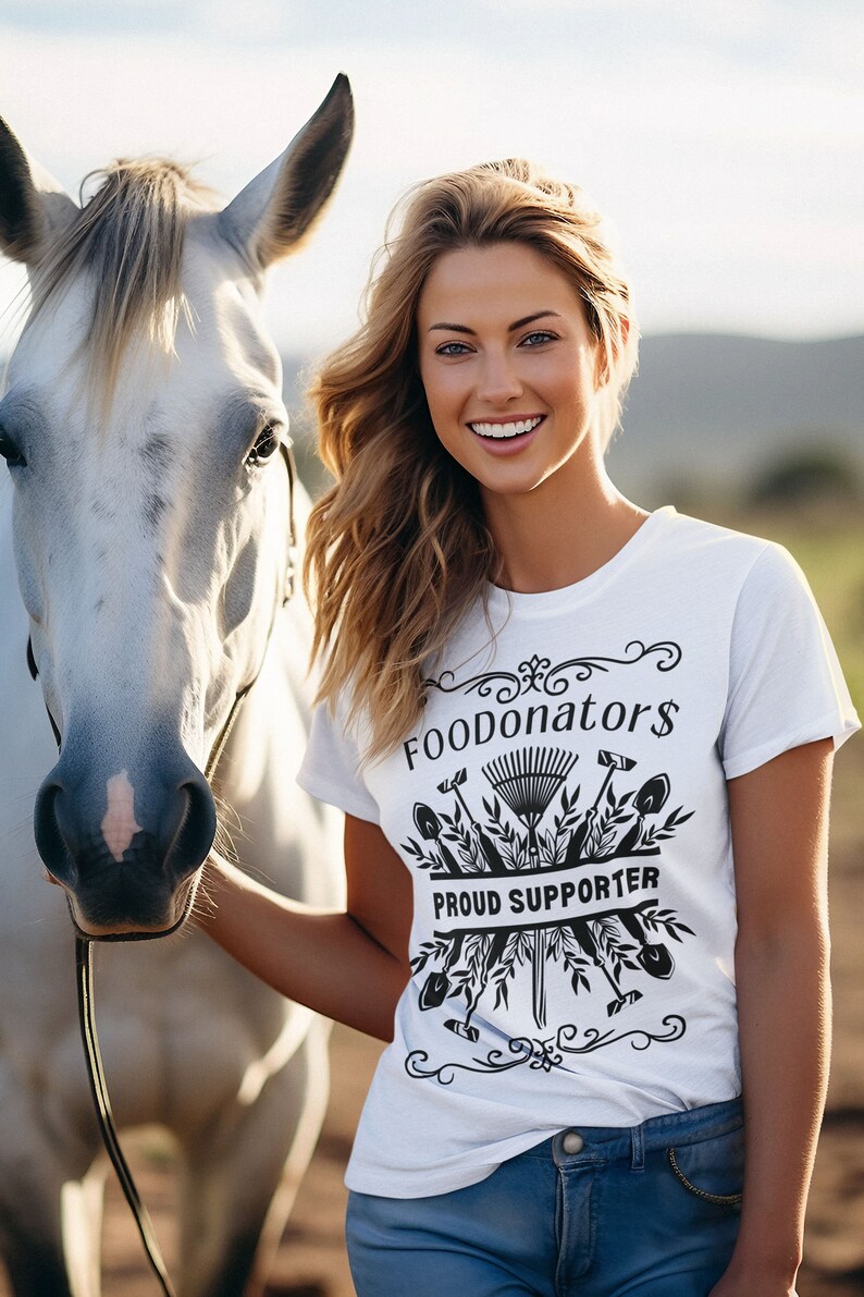 White and black gardening shirt saying FOODonator$ proud supporter.