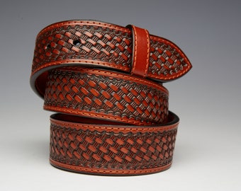 May include: A brown leather belt with a woven pattern. The belt is folded in thirds, showing the detail of the design.