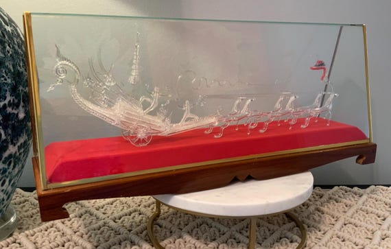 A vintage Thai estate-find dragon chariot pulled by six horses, all in hand-blown glass on an ornate acrylic/wood/velvet display — genuinely one-of-a-kind and impossible to replicate.