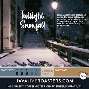 May include: An advertisement for "Twilight Snowfall" coffee, featuring a snowy outdoor scene with a lamppost. The text describes the winter mix. The net weight is 12oz.