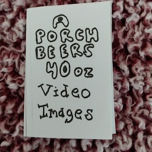 May include: A white card with black handwritten text that reads "A Porch Beers 40 oz Video Images".