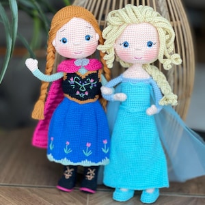 Handmade crocheted amigurumi dolls of Elsa and Anna, inspired by Frozen. Detailed with colorful outfits, perfect for custom name personalization or gifting.