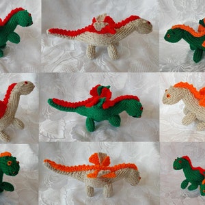 May include: Nine knitted dragon toys in various poses. The dragons are made with beige, green, and orange yarn. Some dragons have red accents.