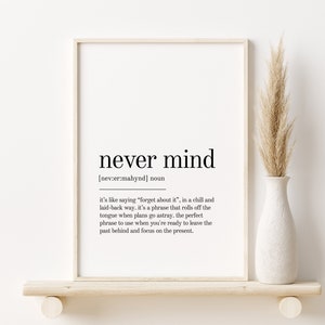 May include: A black and white printable wall art print with the definition of the phrase "never mind". The definition is written in a minimalist font style.