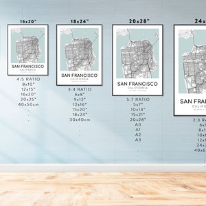 May include: Framed art prints of San Francisco city map in various sizes, including 11x14 inches, 16x20 inches, and 24x36 inches. The maps feature a minimalist design with a light blue background and black and white city details.