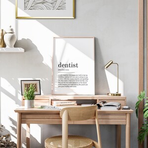 May include: A minimalist home office desk with a framed print that reads "dentist | /ˈdɛntɪst/ | noun | a skilled professional who keeps your teeth in tip-top condition, making sure your grin is always in top position. With their dental weaponry and sparkling wit, they make a visit to the dentist feel like a bit of a treat. They are the true champions of the dental world, keeping your teeth shining like pearls and your gum healthy and nourished."