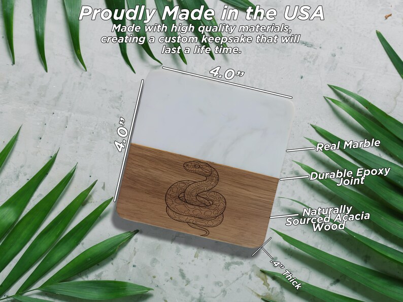 a marble coaster with a snake design, surrounded by green leaves.