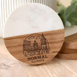 May include: A set of three ceramic mugs with a speckled, matte finish. The mugs are in shades of cream, light gray, and dark gray. Each mug has a simple, minimalist design, perfect for coffee or tea.
