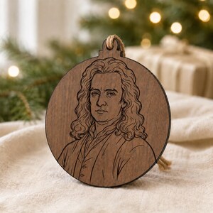 May include: A round, wooden Christmas ornament featuring a detailed engraving of a man with long, curly hair. The ornament has a natural wood grain finish and a jute string for hanging. The man's portrait is the focal point.