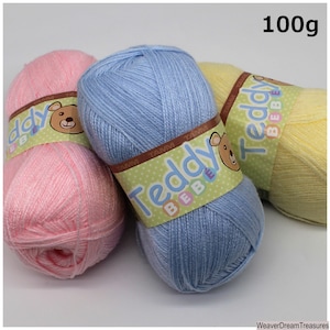 May include: Three balls of yarn in pink, blue, and yellow. Each ball is labeled "Teddy Bebe" and weighs 100 grams.