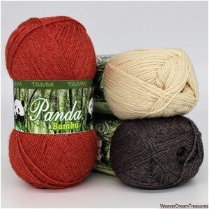 May include: Three skeins of Panda Bamboo yarn in red, beige, and brown. The yarn is labeled "Panda Bambu" with a panda bear logo.